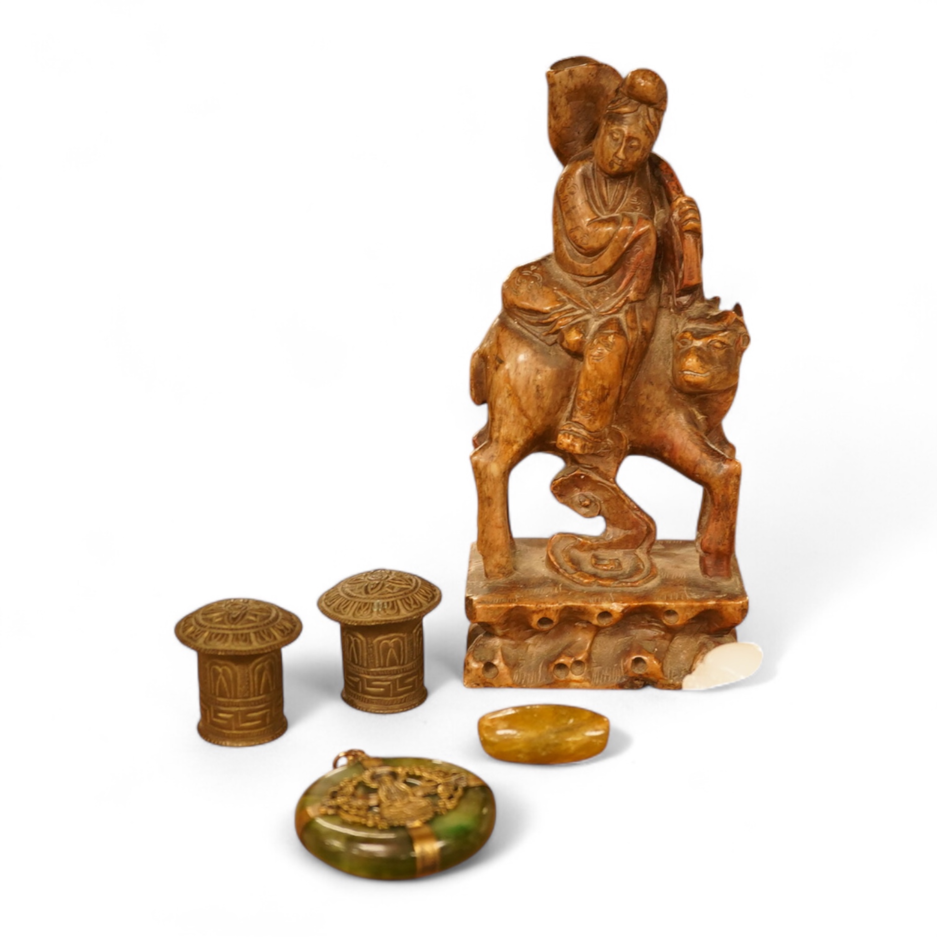 Chinese items comprising a soapstone carving, three jade carvings, one with gilt metal pendant mounts and two brass knops